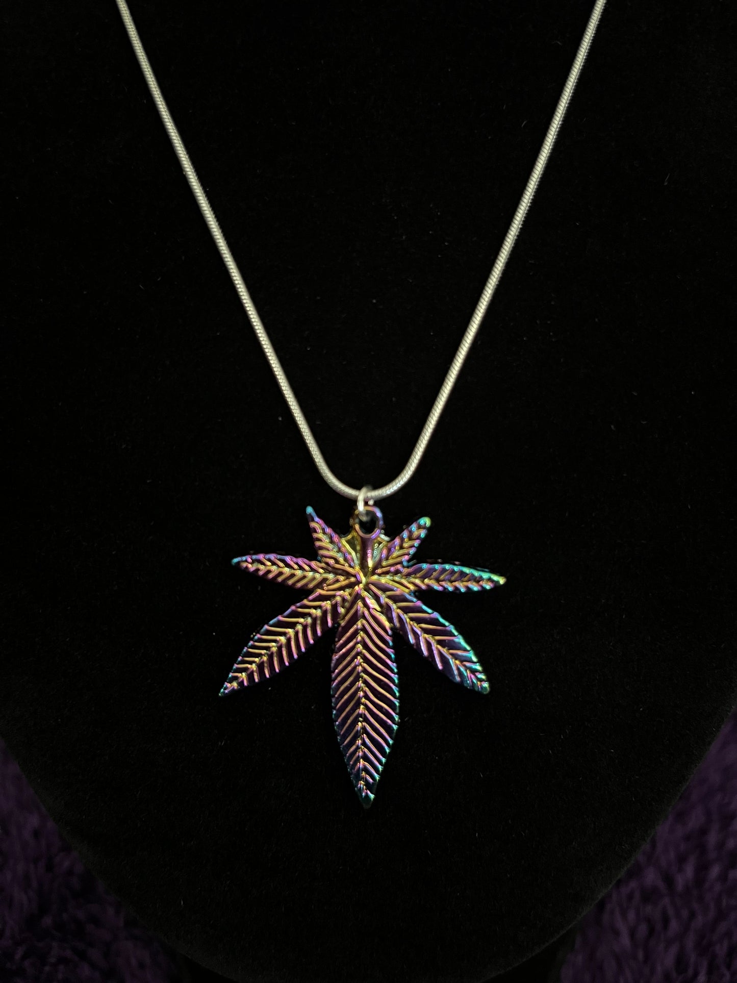 Multi colored pot leaf charm on 16” silver plated necklace