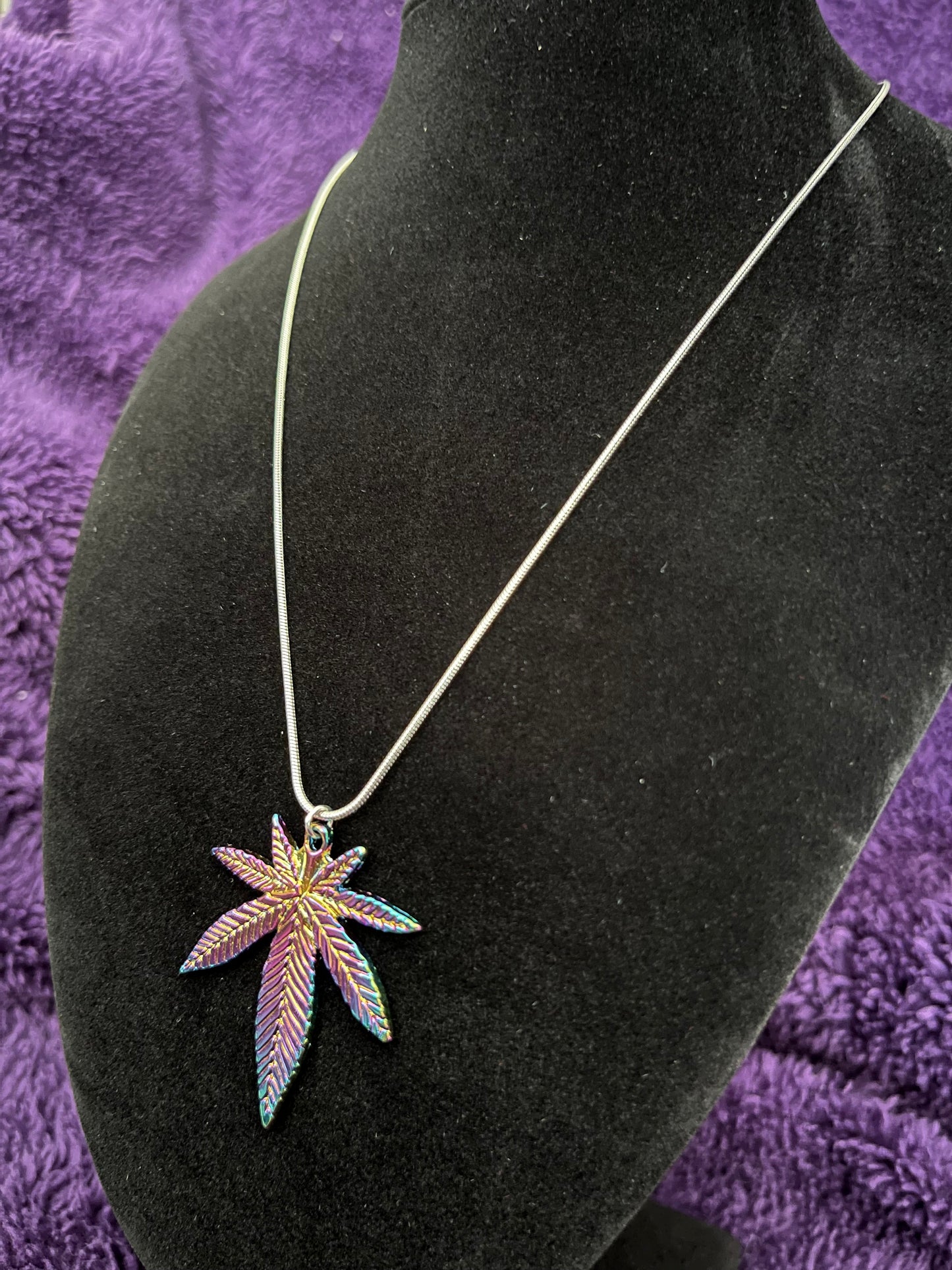 Multi colored pot leaf charm on 16” silver plated necklace