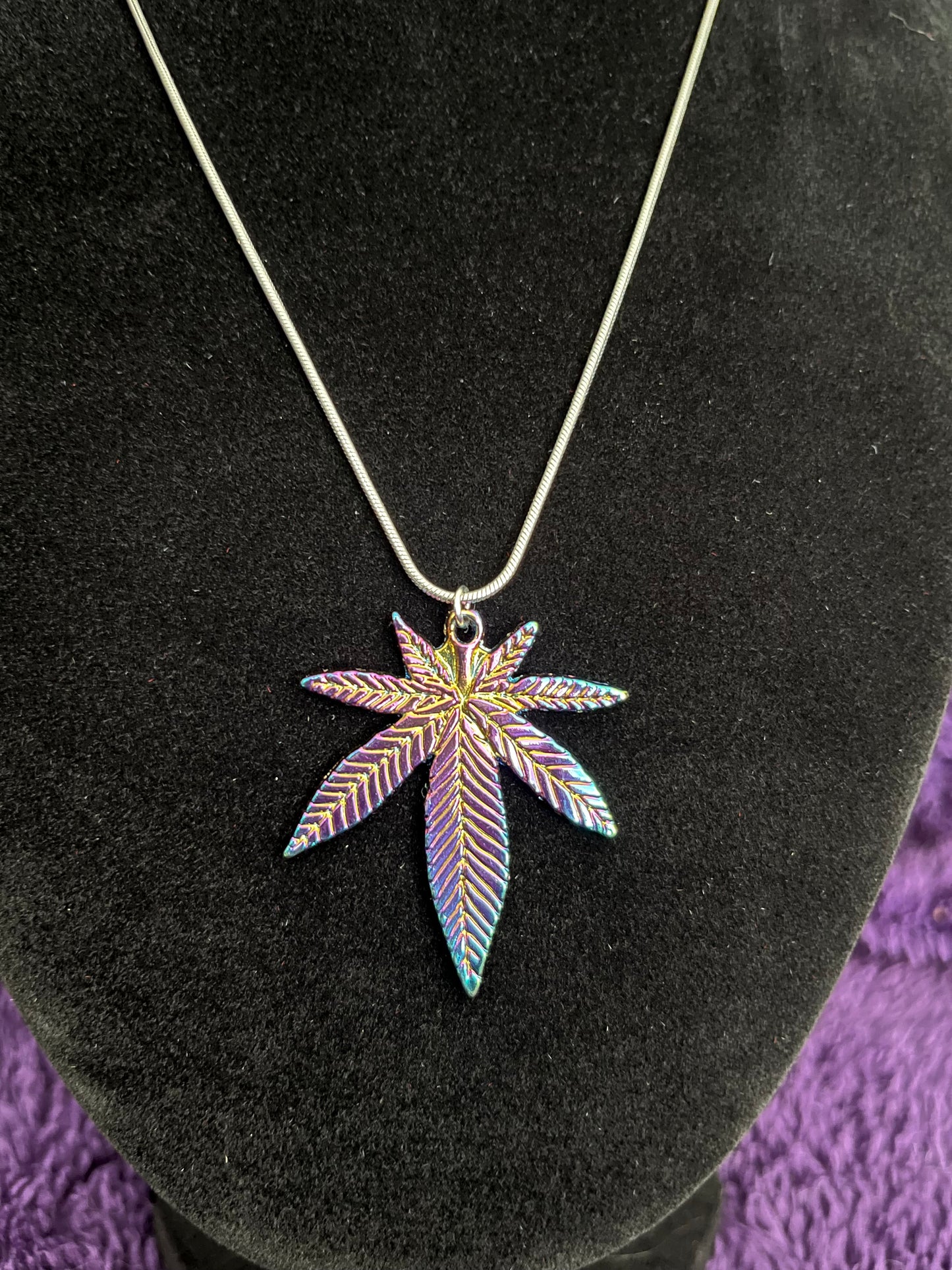 Multi colored pot leaf charm on 16” silver plated necklace